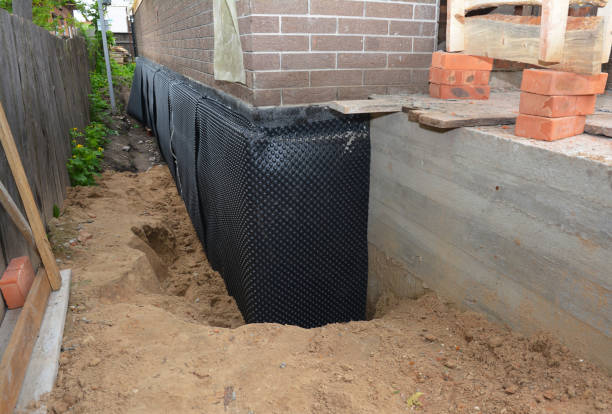 Happy homeowners after waterproofing job in Fayette